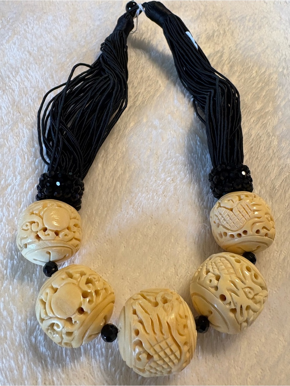 Carved Ivory-Tone Bead Statement Necklace with Black Tassels
